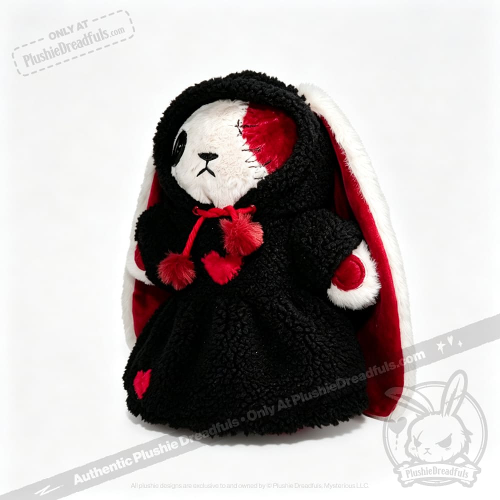 Stuffed bunny in a black Plushie Hoodie with heart details and red accents stands against a white background.