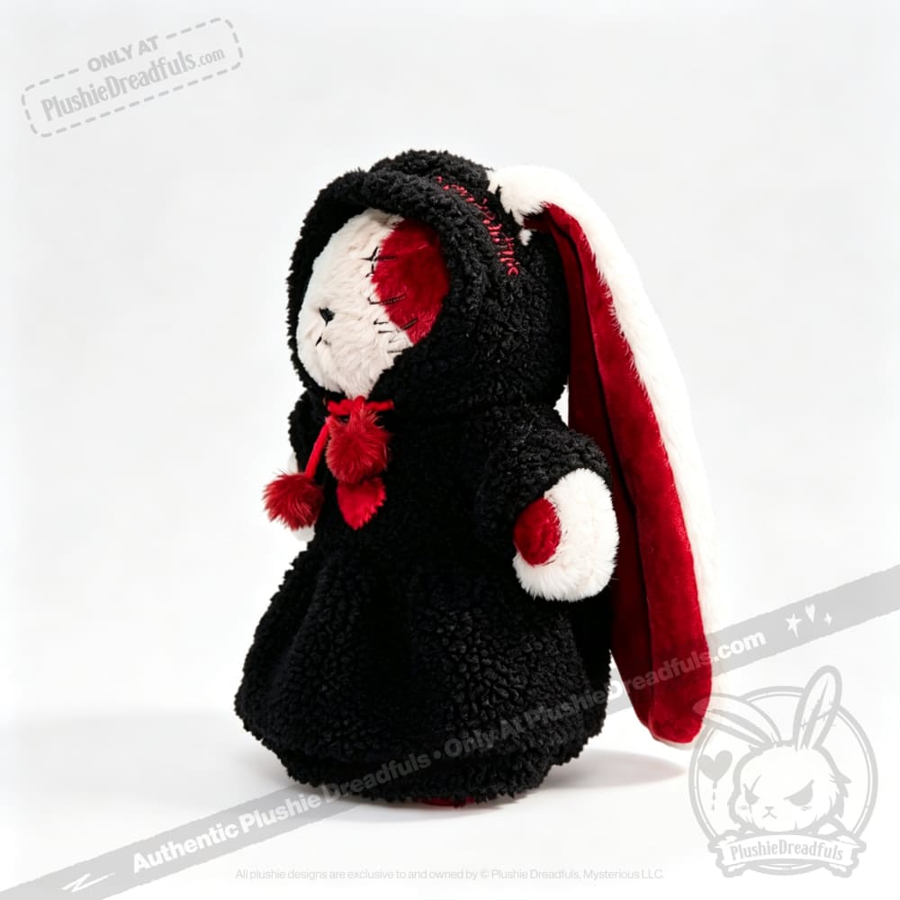 Stuffed bunny in a Plushie Dreadfuls black hooded robe with red and white lining, standing on a white background.