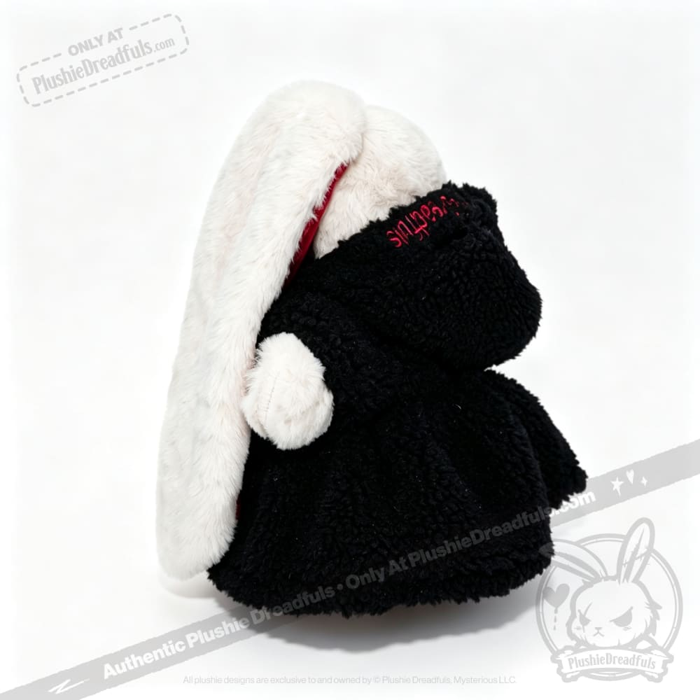 Plushie Dreadfuls bunny in a black Plushie Hoodie, long white ears, turned away on a crisp white background.