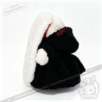 Plushie Dreadfuls bunny in a black Plushie Hoodie, long white ears, turned away on a crisp white background.