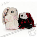 Two plush bunnies with button eyes wear Fuzzy Dress Hoodies: one white-pink, the other black with red hearts.