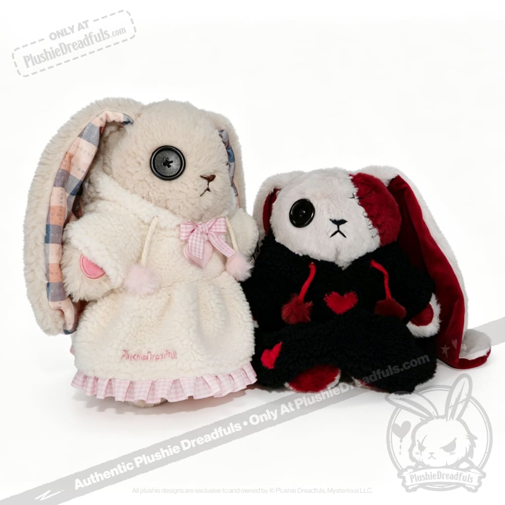 Two plush bunnies with button eyes wear Fuzzy Dress Hoodies: one white-pink, the other black with red hearts.