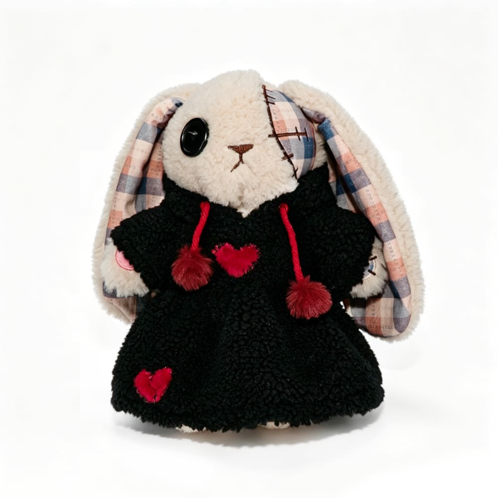 Plushie Dreadfuls bunny in a black dress with red hearts, plaid ears, and button eye on a white background.