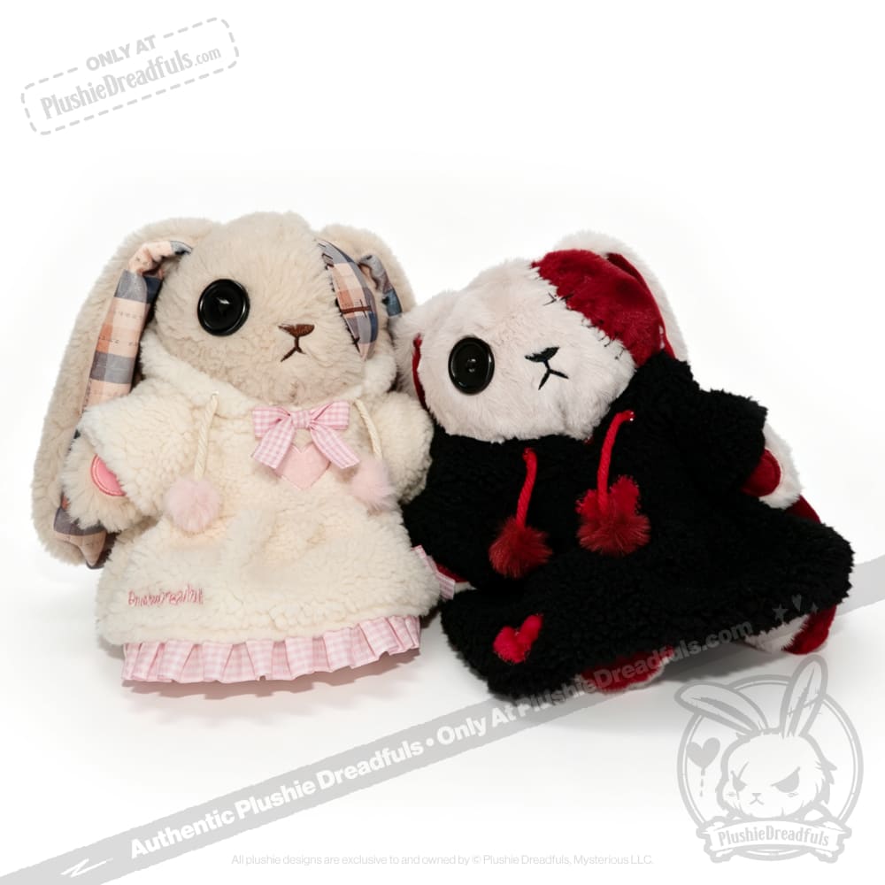 Two Plushie Dreadfuls in Fuzzy Dress Hoodies, one in white and pink, the other in black and red, sit side by side.