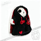 Plushie Dreadfuls bunny in a black hooded coat with red hearts and a large black button eye.