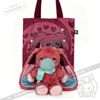 Plush pink awareness rabbit with long ears and scarf sits by a pink tote bag—thoughtful chronic illness gift.