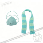 A blue knit face mask and blue-and-white striped scarf—perfect as a chronic illness gift or Long COVID plushie accessory.
