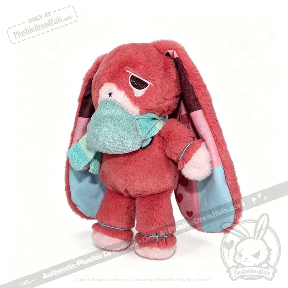 Pink plush bunny with long ears, a teal scarf and mask—an awareness rabbit plushie symbolizing chronic illness.