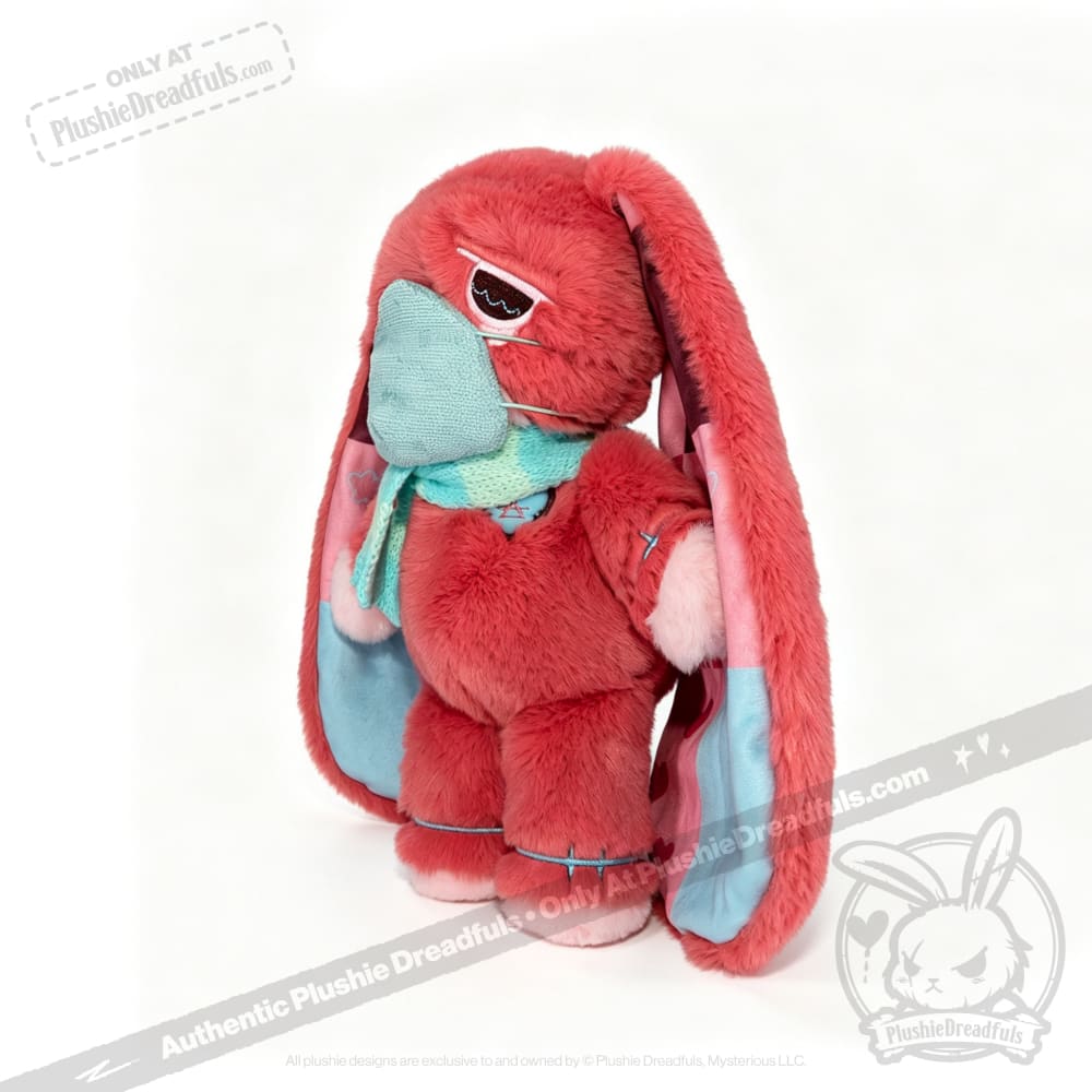 Plush pink bunny with long ears, blue scarf and mask—a charming Long COVID plushie for chronic illness awareness.