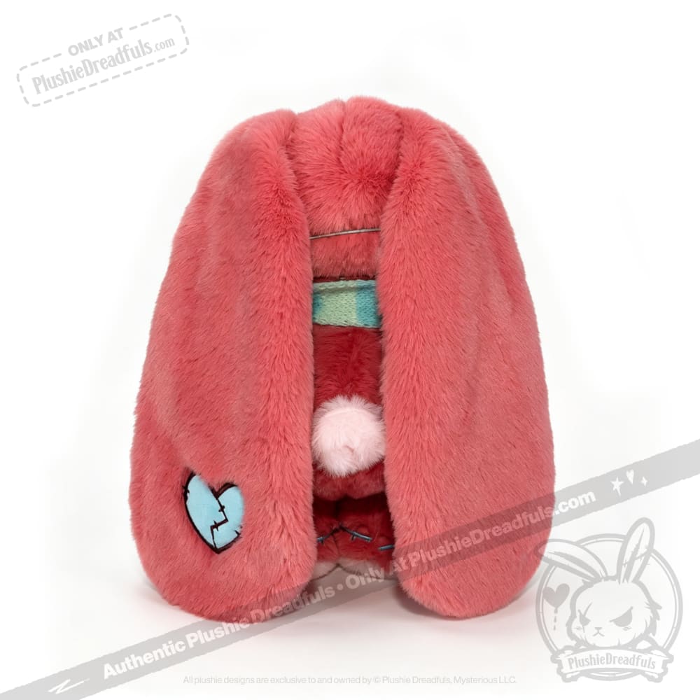 A plush pink bunny hood with long ears, a broken blue heart patch—perfect as a chronic illness gift.
