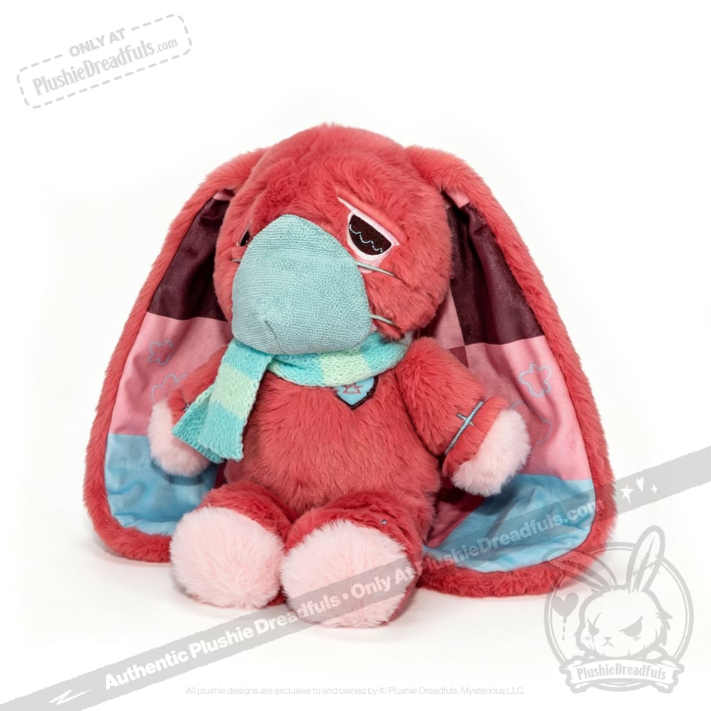 A pink awareness rabbit plushie with a teal mask and scarf sits on a white background, perfect as a chronic illness gift.
