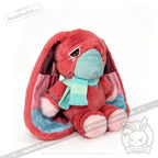 Plush pink bunny with long ears, teal face mask, and striped scarf—an awareness rabbit and chronic illness gift.
