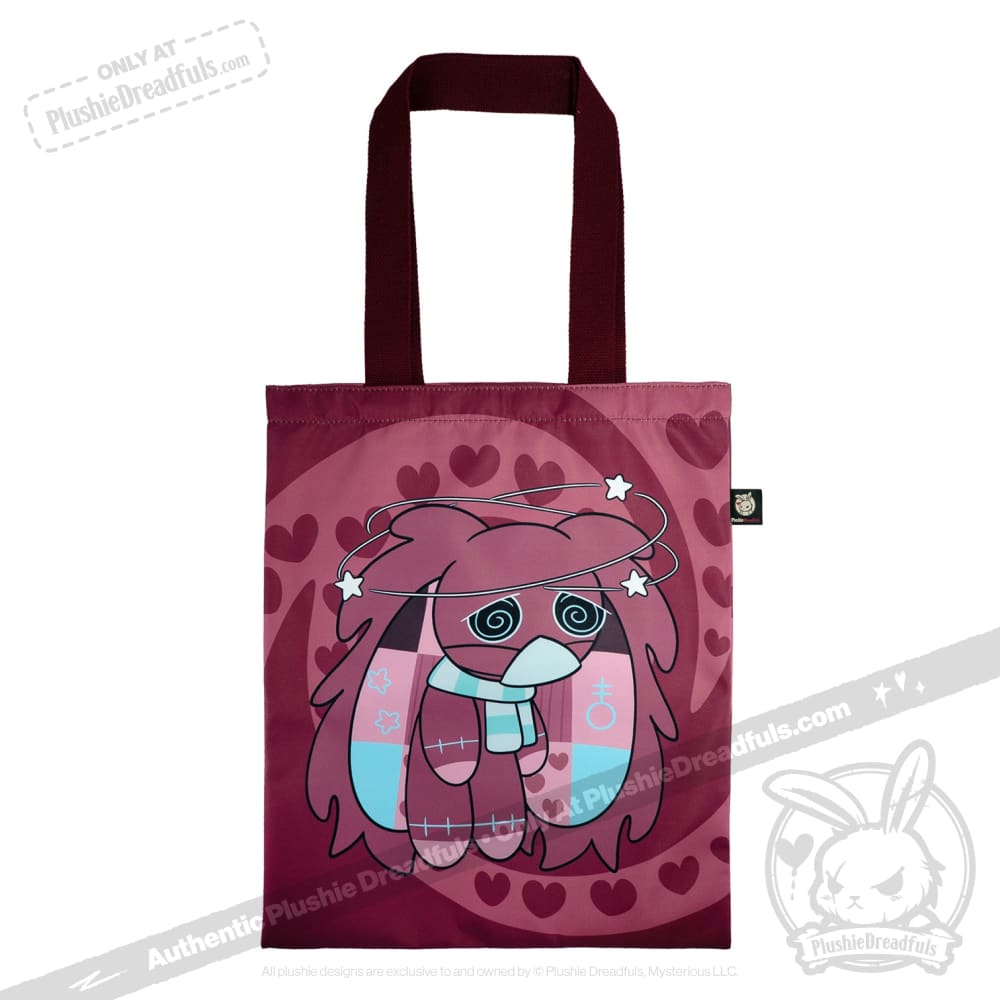 Maroon tote bag with awareness rabbit cartoon, heart patterns, swirly eyes, patchwork details, and dark handles.
