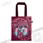 Maroon tote bag with awareness rabbit cartoon, heart patterns, swirly eyes, patchwork details, and dark handles.