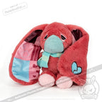 Sad pink awareness rabbit with long ears, blue scarf, and broken heart patch—a tender chronic illness gift.
