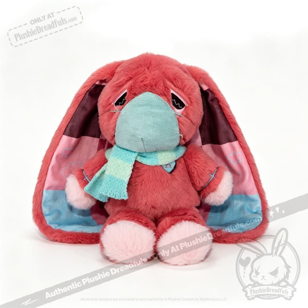 Pink plush bunny with droopy ears and mask, an adorable awareness rabbit, sits in a teal scarf on white background.