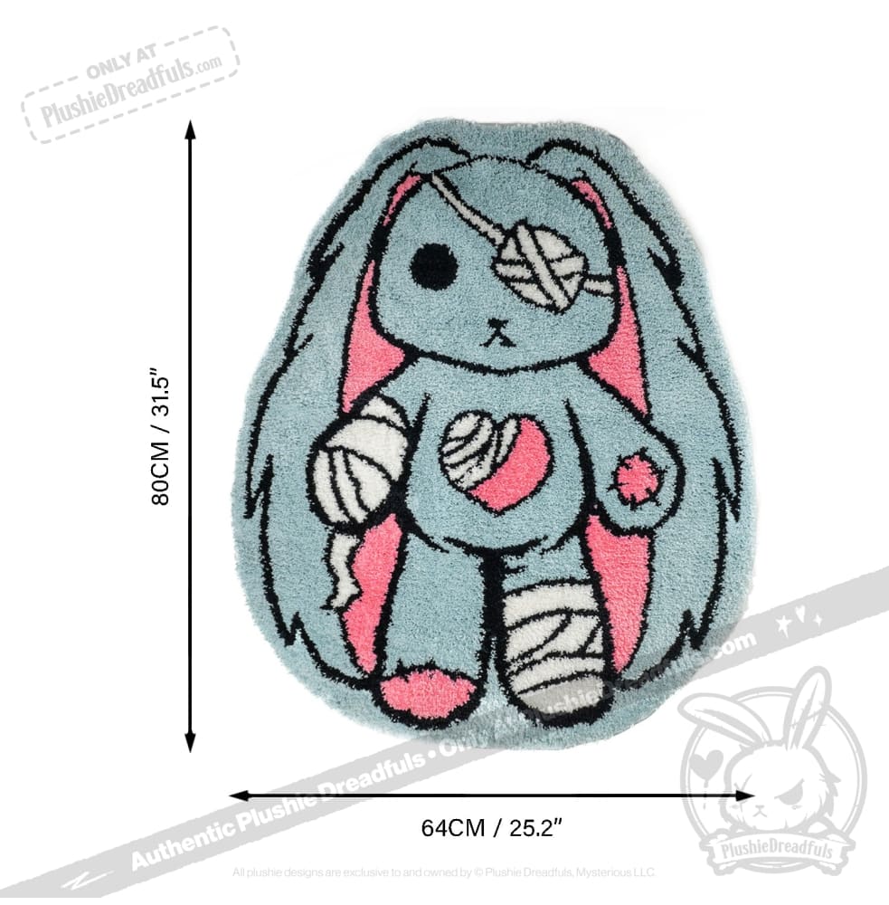 Ouchie Rabbit Rug: A blue and pink bunny rug with bandages, measuring 80cm x 64cm from Plushie Dreadfuls.