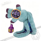 A teal Plushie Dreadfuls dragon with purple accents holds a lantern, featuring shiny blue zodiac stuffed animal details.