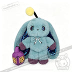 A teal Pisces Rabbit plushie with iridescent wings, purple paws, and a lantern—part of the Plushie Dreadfuls zodiac series.