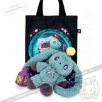 Plushie Dreadfuls Pisces Rabbit plush with sparkly ears holds a lantern in front of a magical creature tote bag.