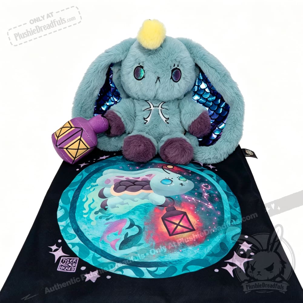 Blue Pisces Rabbit plush with shiny blue ears sits on a black bag featuring its matching fantasy illustration.