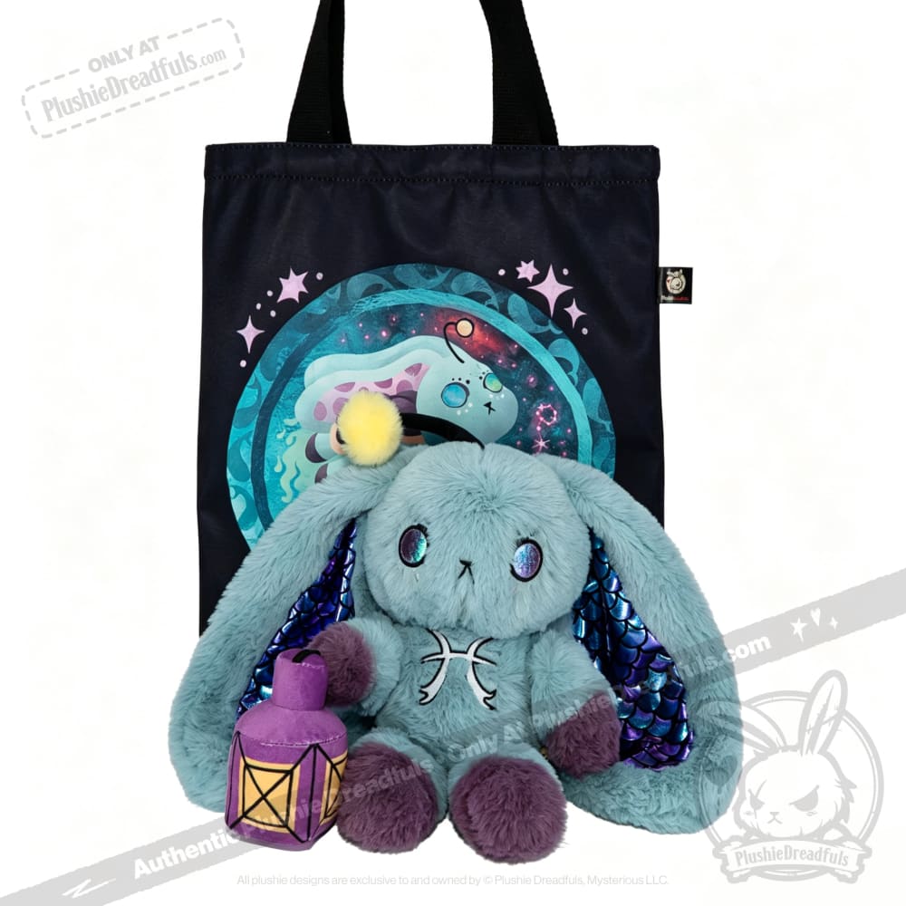 Blue Plushie Dreadfuls bunny with yellow pompom holds a lantern, sitting by a fantasy-themed black tote bag.