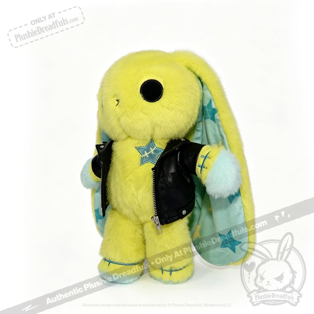 Yellow plush bunny with long ears, a faux leather jacket, and star-patterned blue inner ears, standing upright.