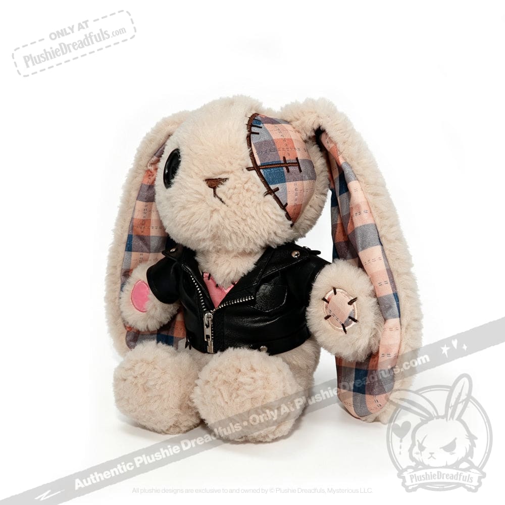 Plush bunny with plaid ears, an eye patch, and a faux leather jacket, sitting on a white background.