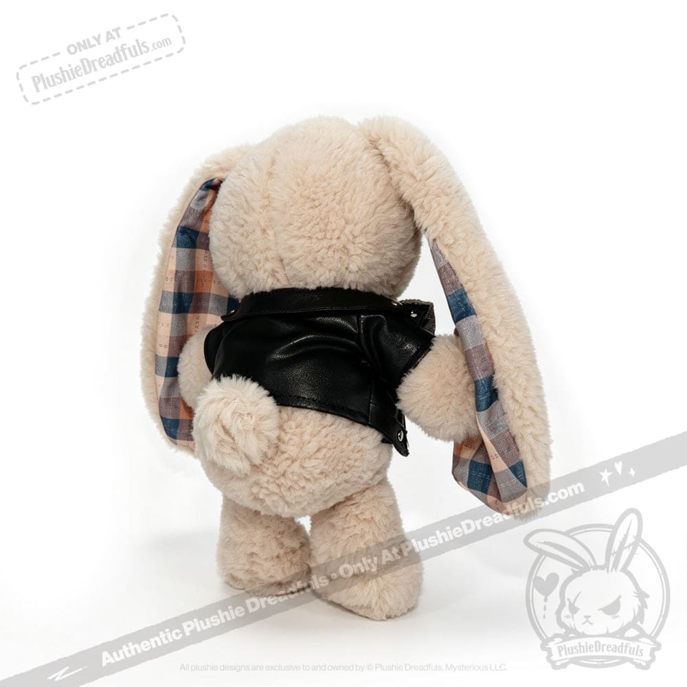 Plush bunny in a black faux leather jacket, showing its back, with plaid inner ears on a white background.