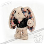 Plush bunny with plaid ears, patchwork details, a faux leather plushie jacket, and a pink heart on its paw.