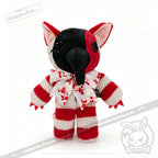 Plushie Dreadfuls toy with striped red and white fur, big ears, black nose, and a splattered white bowtie.