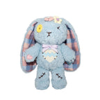 Blue Plushie Dreadful bunny with a yellow button eye, flower details, plaid ears—an adorable stuffed animal to cherish.