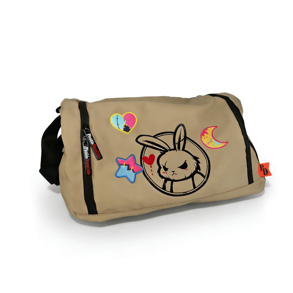 Tan messenger bag with cartoon bunny, plushie clothes, night sky iron on patches, side zipper, and black shoulder strap.