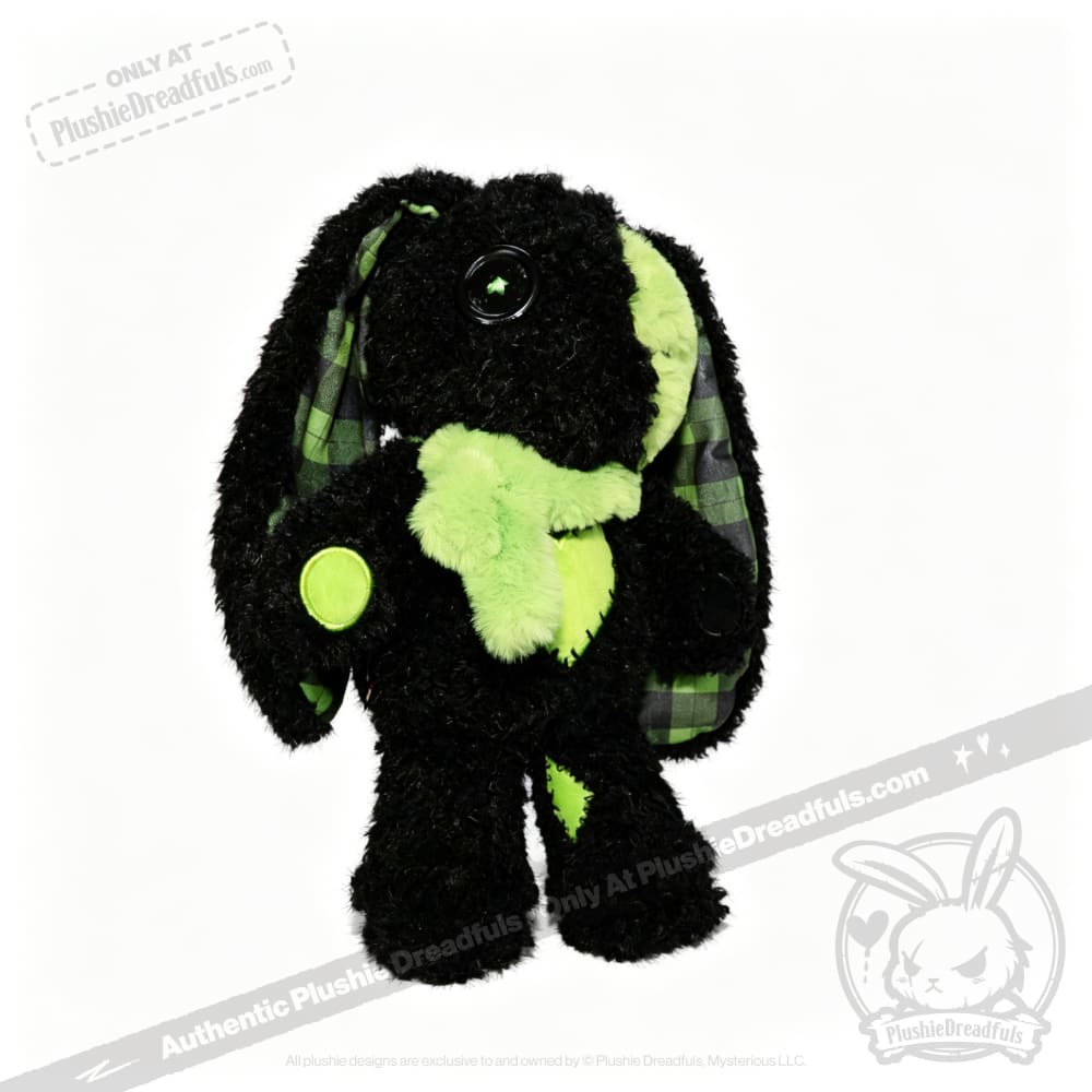 A Plushie Dreadfuls black bunny plush stuffed animal with green accents, button eyes, and plaid inner ears.