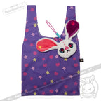 Purple reusable shopping bag with yellow stars, pink hearts, and a Harajuku Alice Rabbit plushie dreadfuls keychain attached.