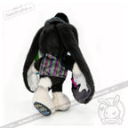 Plushie bunny with long black ears, ADHD Mad Hatter-inspired clothes, and white feet, shown from the back.