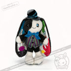 Quirky plushie bunny with ADHD Mad Hatter vibes, mismatched eyes, a striped vest, bow tie, top hat, and colorful ear buttons.