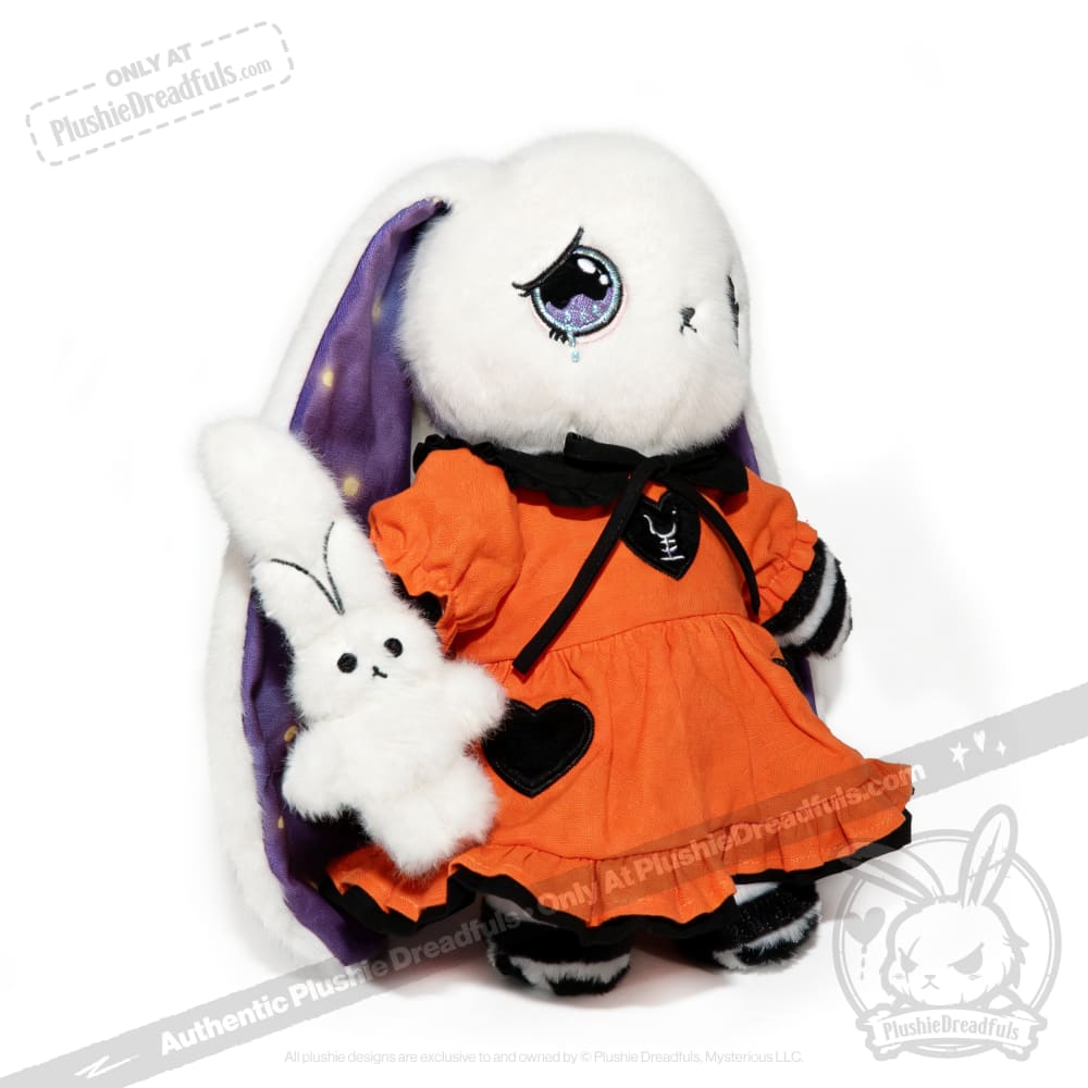 White plush bunny in an orange dress with a heart, inspired by the Victorian Anxiety Rabbit, holds a smaller bunny plush.