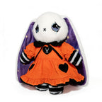 Anxiety Alice Bunny Plush with sad eyes, orange dress, black bow, and star-lined purple cape—your Wonderland plush toy.