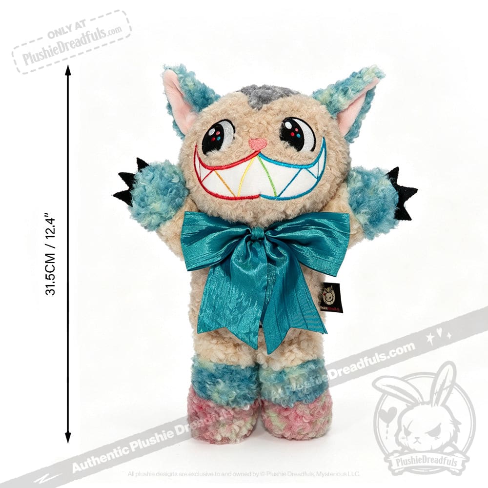 Victorian McGee's Autism Acceptance Cheshire Cat - Plush Stuffed Animal features multicolor fur, a large rainbow grin, a big blue bow, pointy ears, and claws. Shown against a white background with a vertical measurement indicating its height of 31.5 cm (12.4 inches), this whimsical plush toy is inspired by Alice in Wonderland and designed to celebrate autism acceptance.