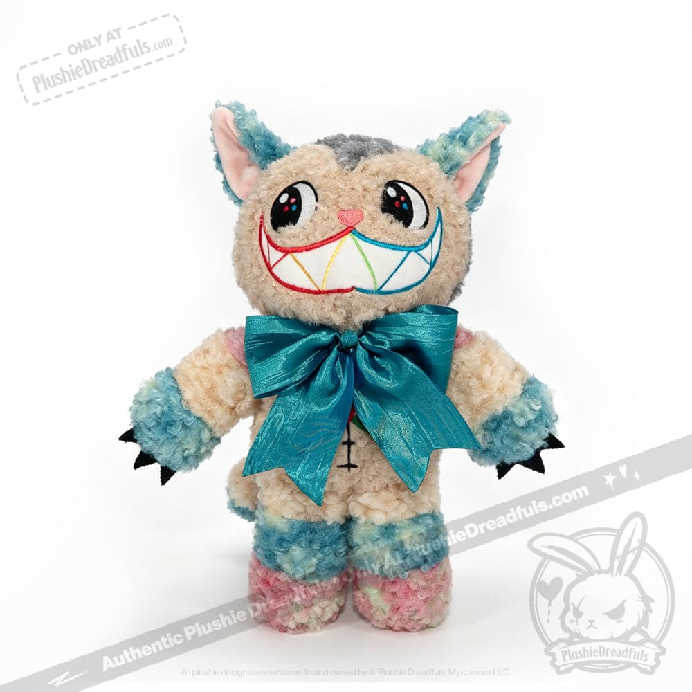 Introducing the Victorian McGee's Autism Acceptance Cheshire Cat - Plush Stuffed Animal: this whimsical plush features blue, pink, and cream fur; large, colorful eyes; a wide rainbow-stitched smile; playful cat ears; black claws; and a big teal bow around its neck. Inspired by Alice in Wonderland and designed to celebrate autism acceptance, this plush stands out beautifully against a white background.