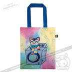 Tote bag with blue handles, a pastel rainbow background, and a cartoon cat sitting on a washing machine—perfect for fans of the Victorian McGee's Autism Acceptance Cheshire Cat plush stuffed animal. Infinity symbols decorate the bag, making it a charming accessory that also supports autism acceptance.