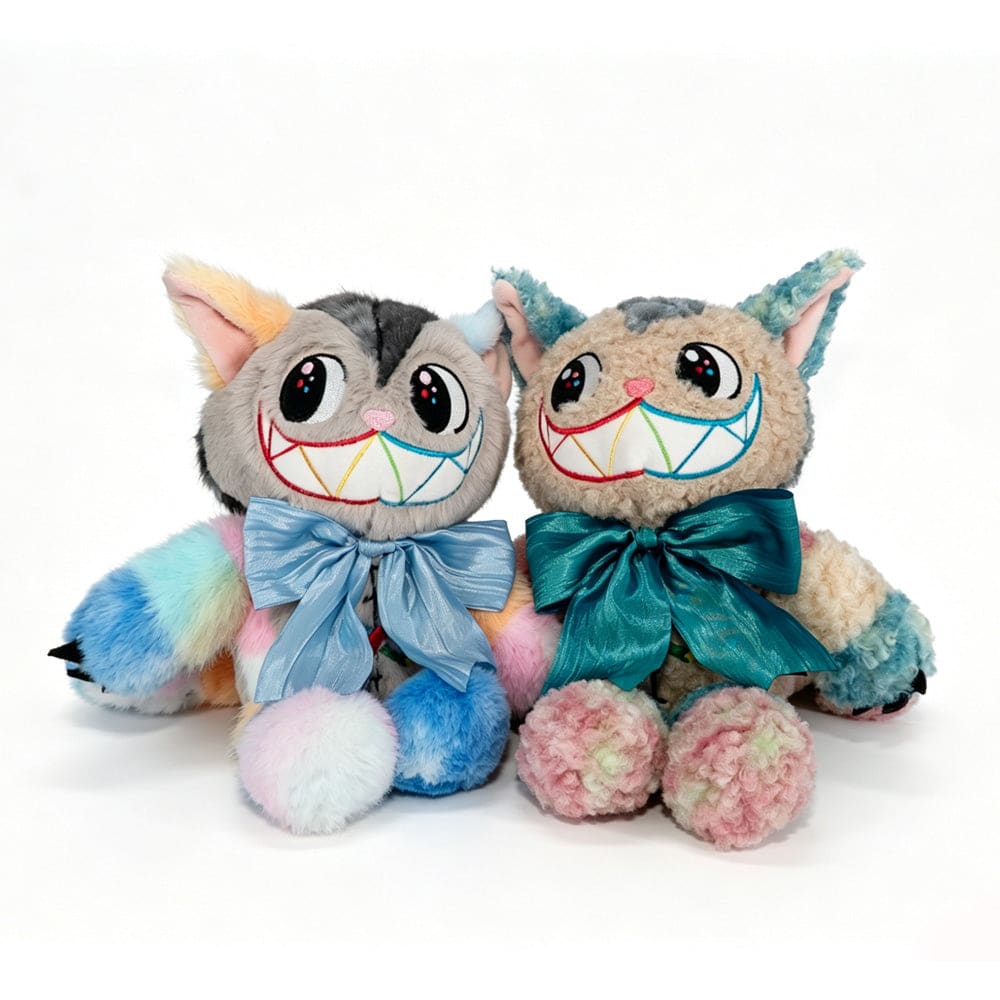Two Victorian McGee's Autism Acceptance Cheshire Cat plush stuffed animals sit side by side against a white background, each featuring big, colorful grins and rainbow fur. Inspired by the whimsical Alice in Wonderland plush style, one cat wears a large blue bow and the other a teal bow, celebrating autism acceptance with their vibrant colors and cheerful expressions.