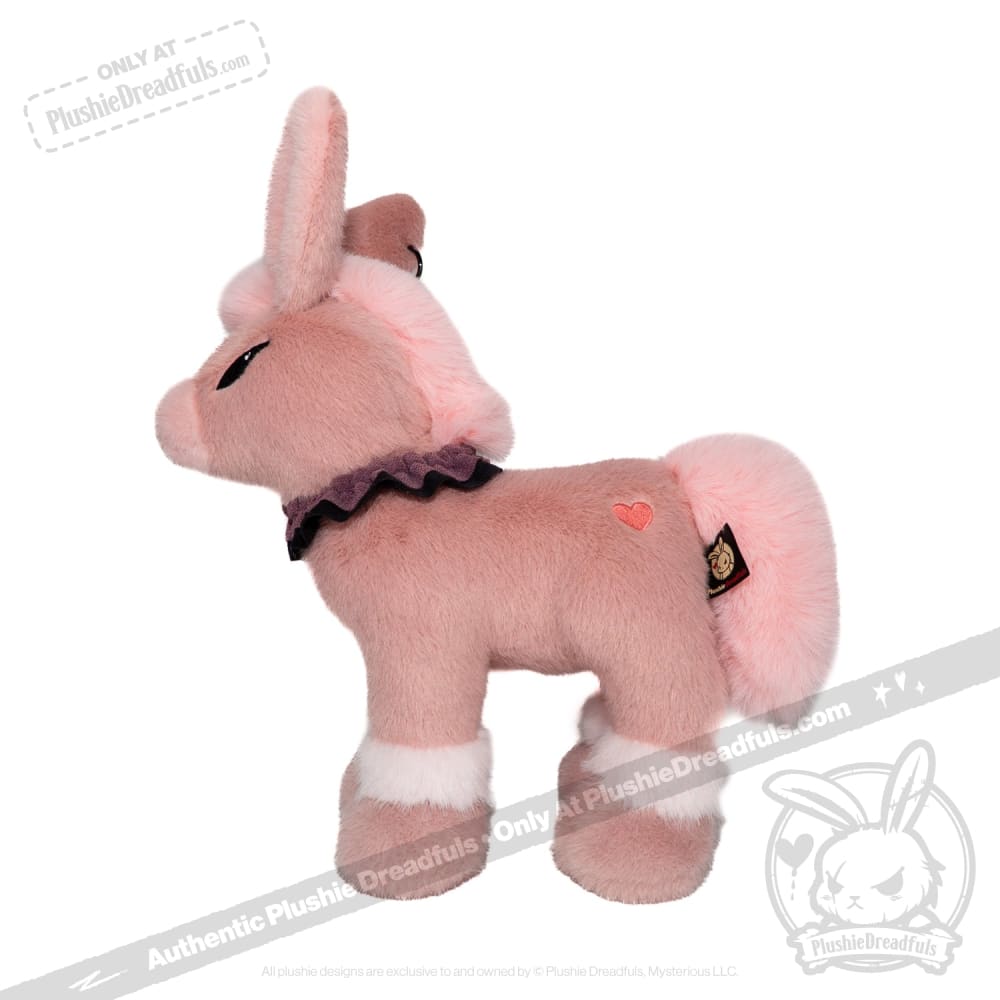 Pink plush unicorn toy with white accents and a heart patch, available now at plushiedreadfuls.com.