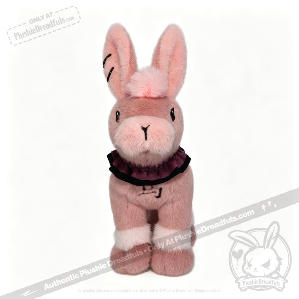 This limited edition plushie bunny features upright ears and a frilly purple collar, available at plushiedreadfuls.com.