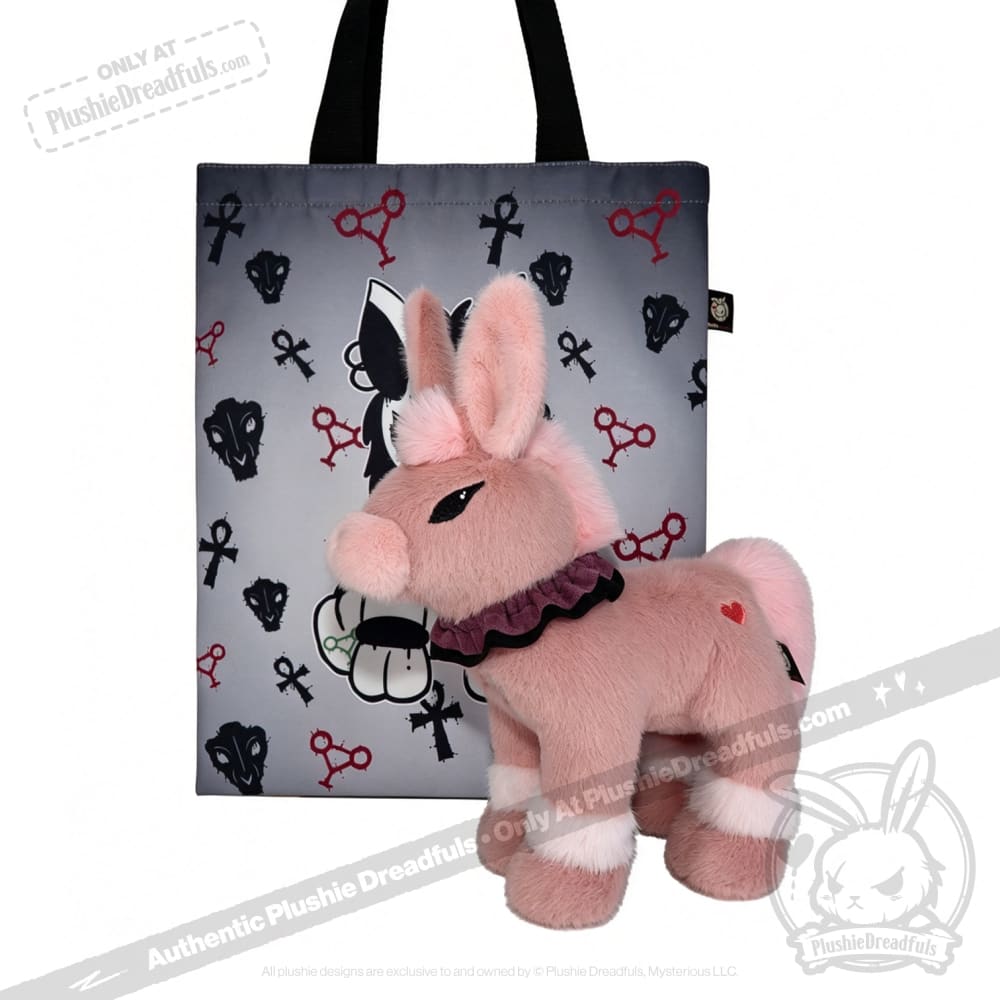 A pink plush donkey with a ruffled collar, from plushiedreadfuls.com, sits before a tote bag with cartoon icons.