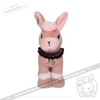 A pink plush bunny from plushiedreadfuls.com with white accents, black collar, and upright stance against a white background.
