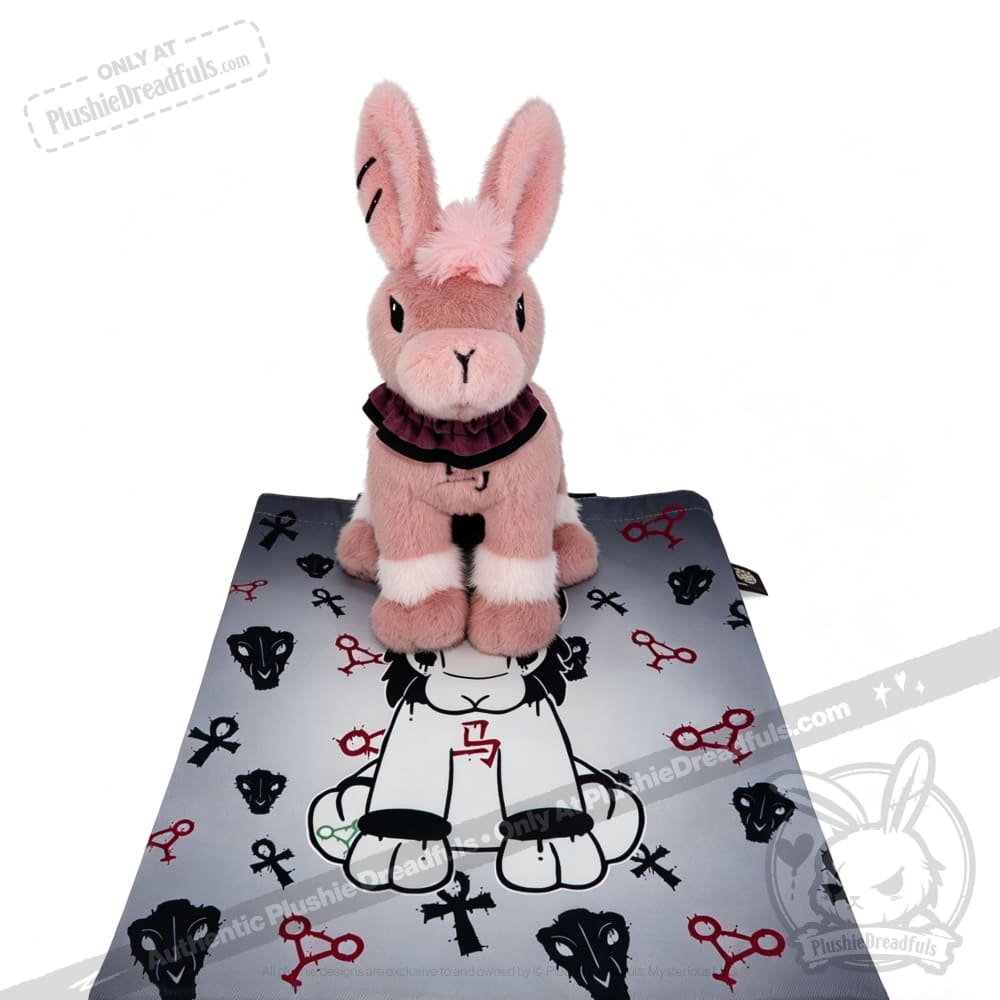 Limited edition plushie: Pink bunny on a mat with scissor designs, from plushiedreadfuls.com.